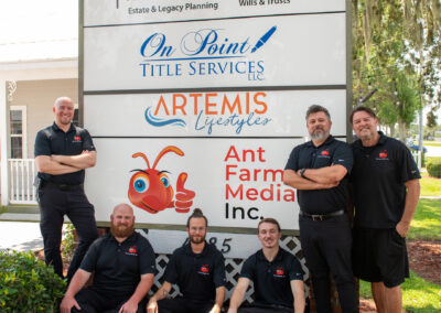 Ant Farm Media team in front of office sign